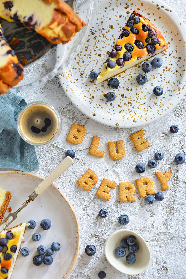 A piece of cheesecake with blueberries on a plate