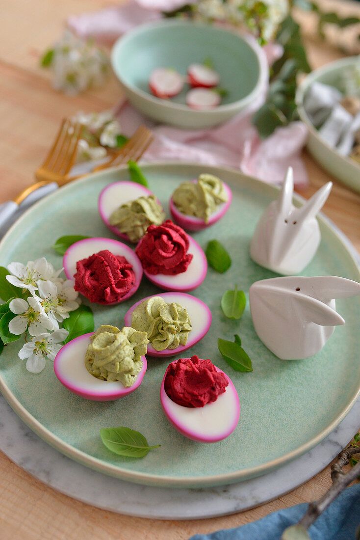 Stuffed Easter eggs on a wooden table flowers bunnies