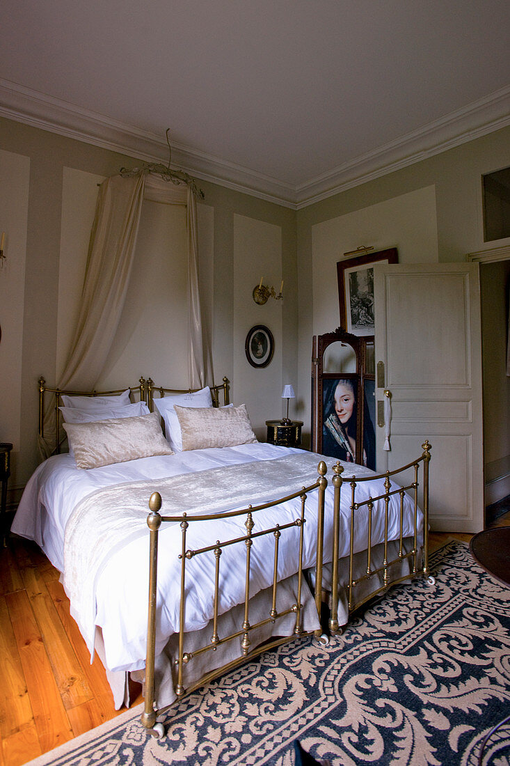 Antique metal beds with bed crown in stylish beige bedroom