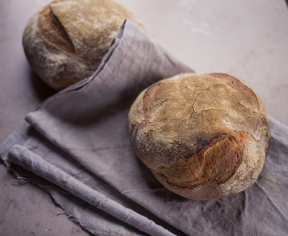 Two loaves of bread on a linen cloth