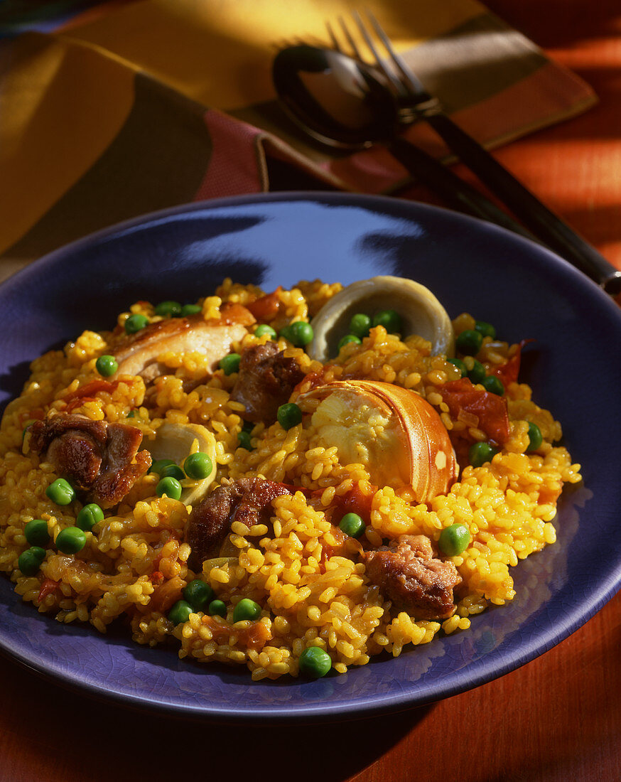 Paella with fish, mussels and peas