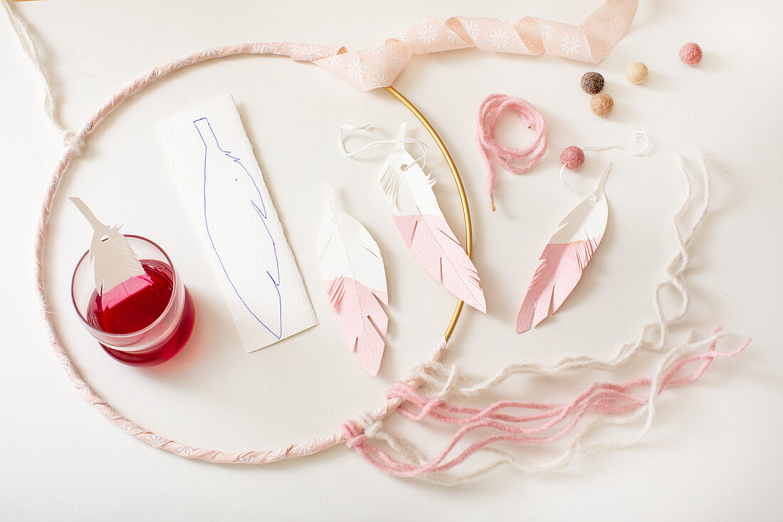 Steps of making a dream catcher with paper feathers