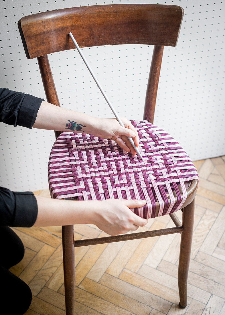 Repairing old chair with handmade woven seat