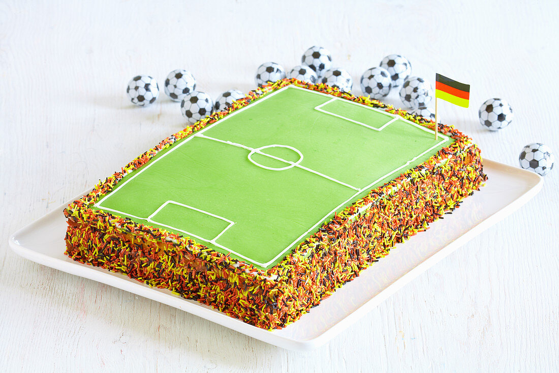 A football pitch cake with sugar sprinkles