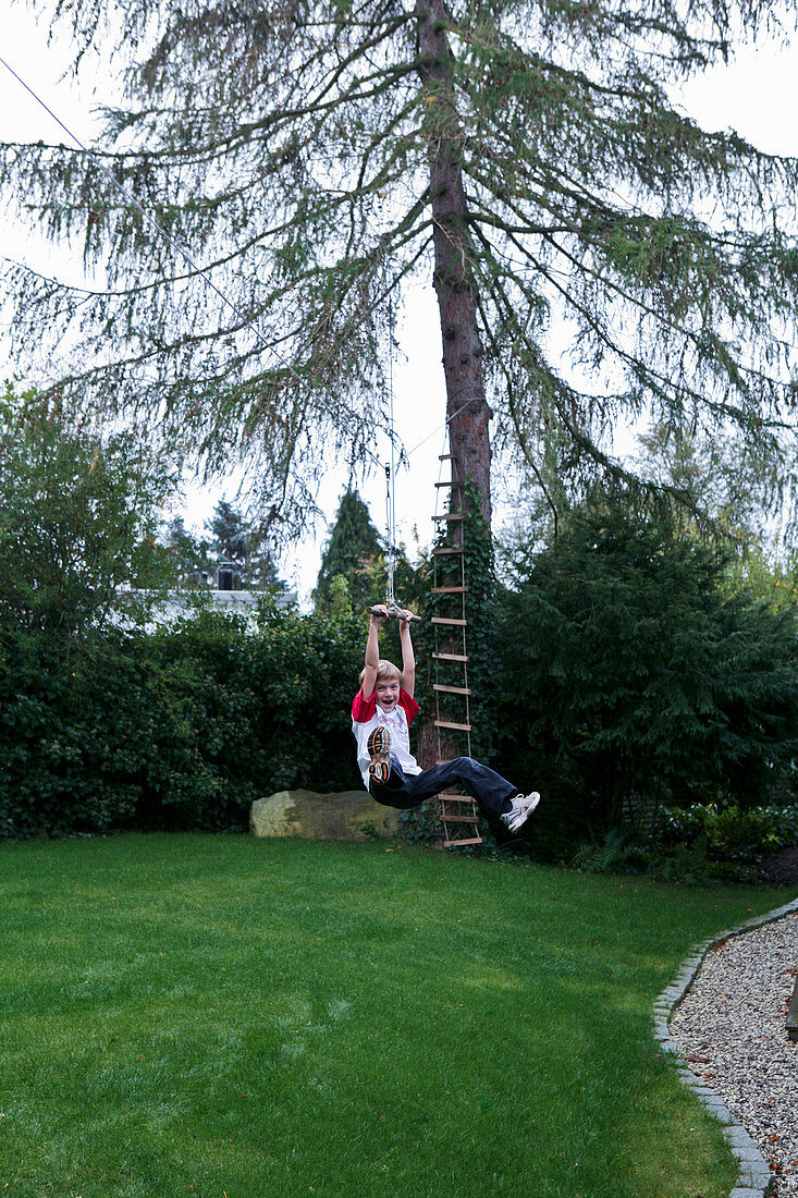 Boy sliding down zipline