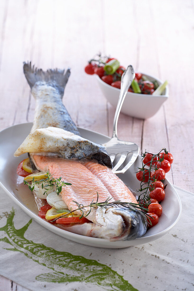 Whole salmon with cherry tomatoes and rosemary