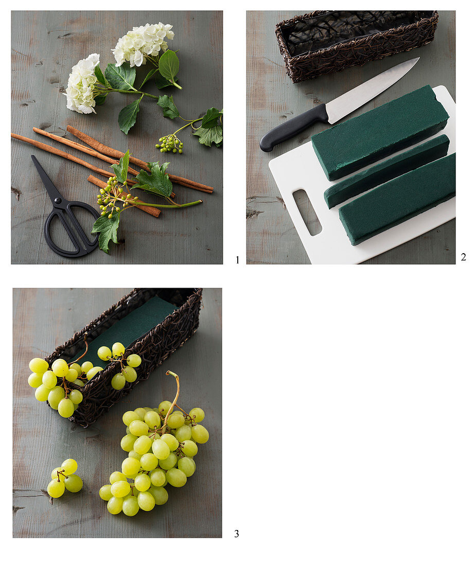 A table centre being made with white hydrangeas, green grapes and cinnamon sticks