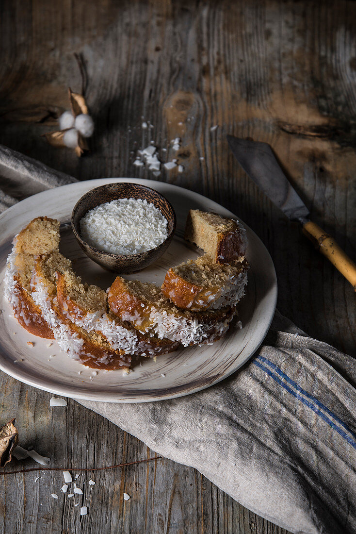 Glazed coconut cake pieces with grated coconut