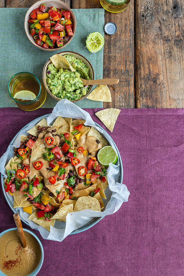 Vegan nachos with guacamole and queso sauce
