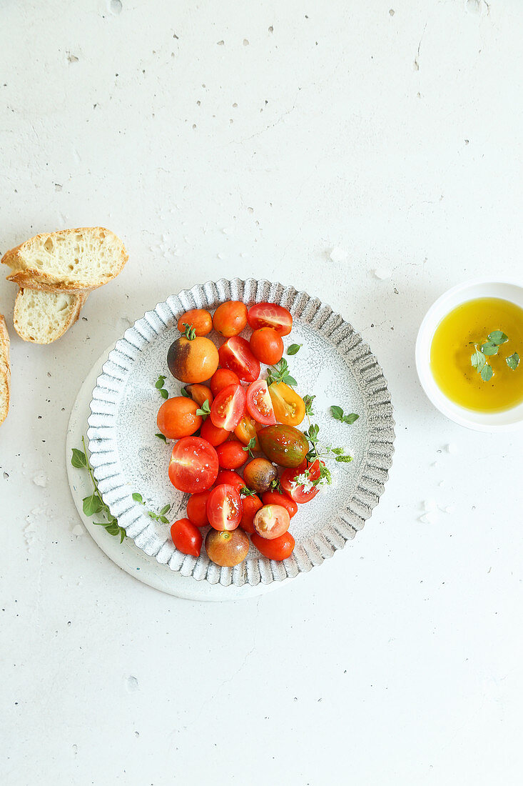 Fresh cherry tomatoes with salt extra virgin olive oil fresh oregano and bread