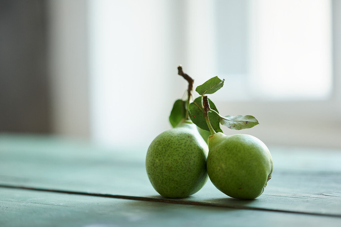 Two butter pears on a wooden table