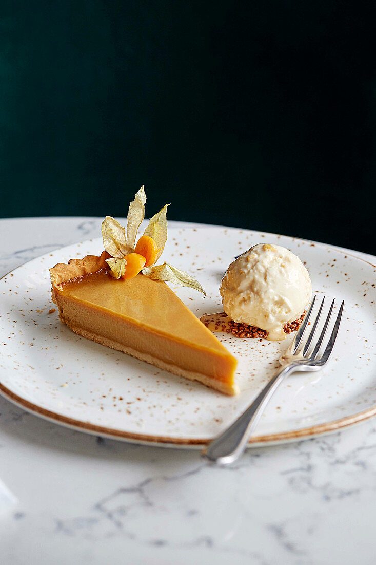 Ein Stück Salted-Caramel-Tarte mit Vanilleeis