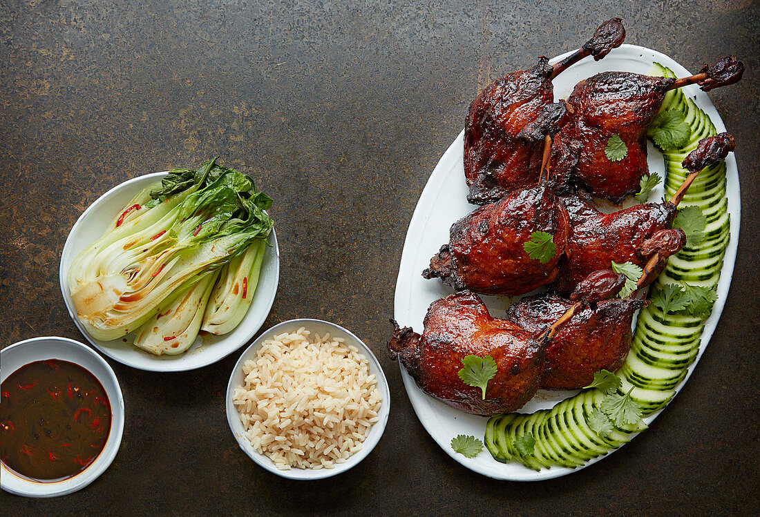 Twice-cooked sticky duck with steamed pak choi