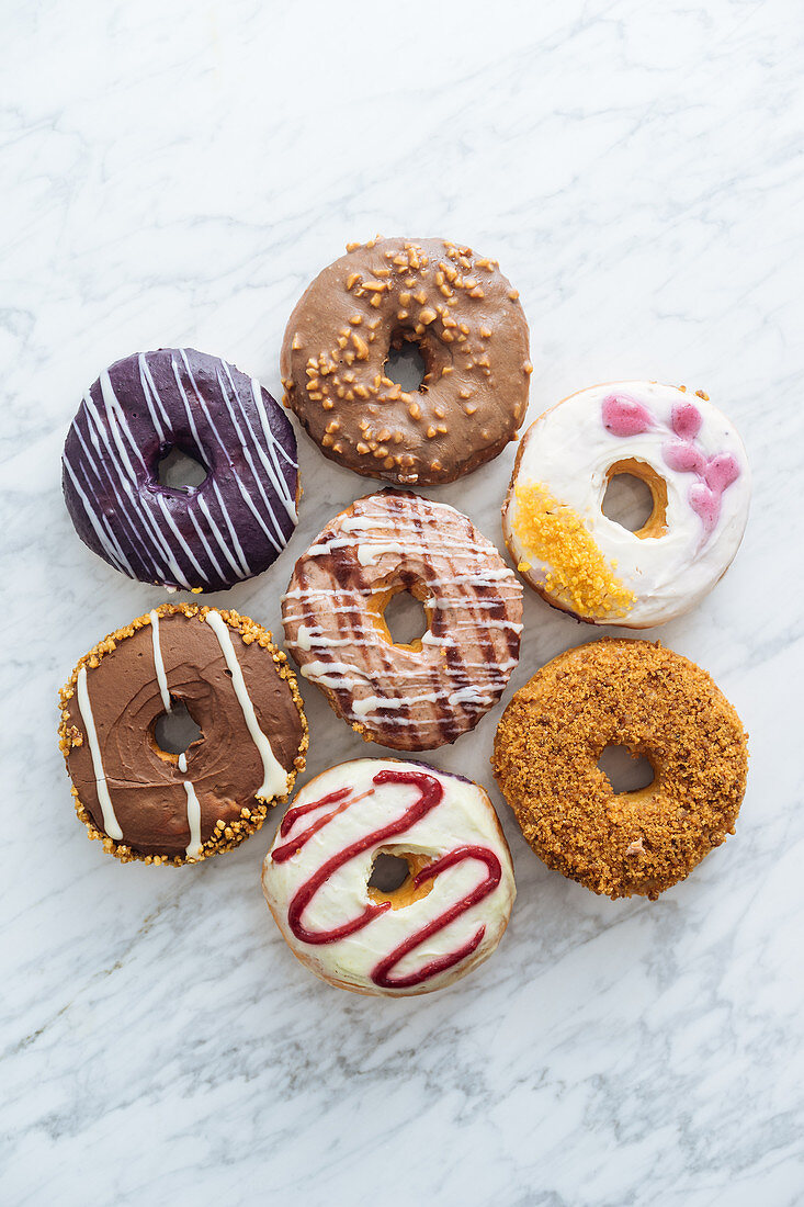 Variety of doughnuts on marble background