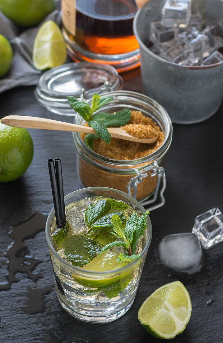Glass of cold mojito made of rum and lime with peppermint, brown sugar