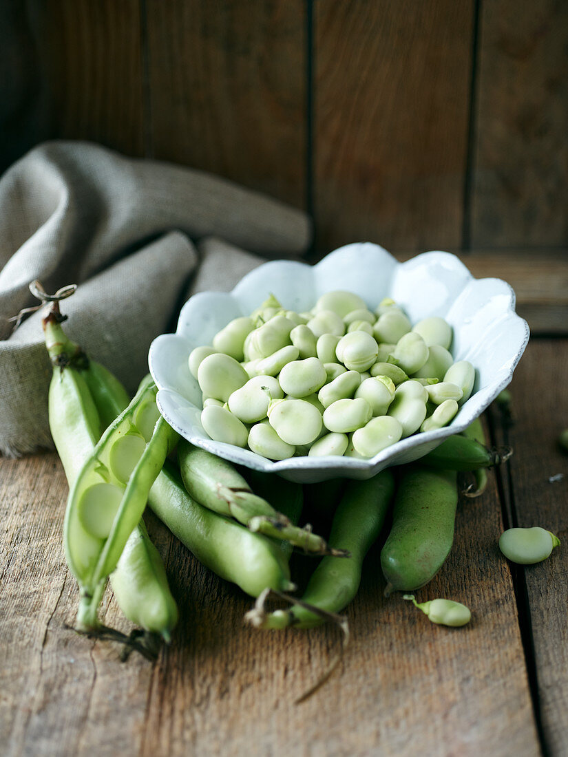 Broad beans in pods and in a bowl