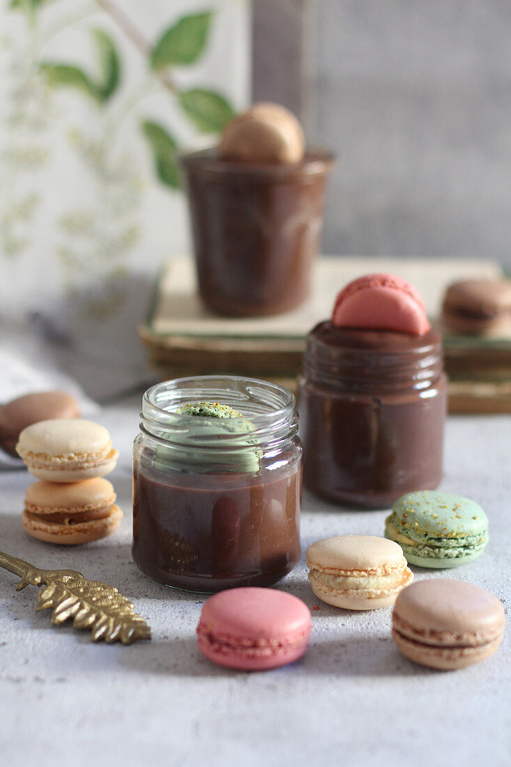 Chocolate mousse in glasses with macarons