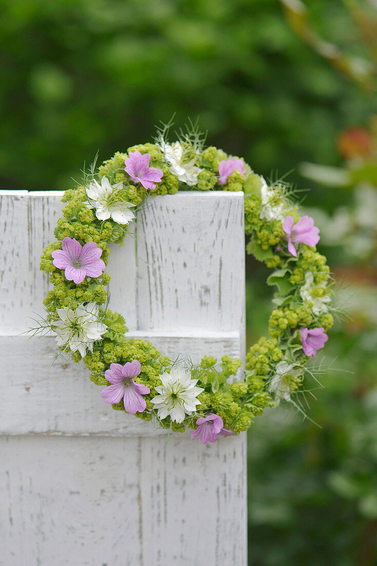 Summer wreath of lady's mantle, cranesbill and maiden in the green