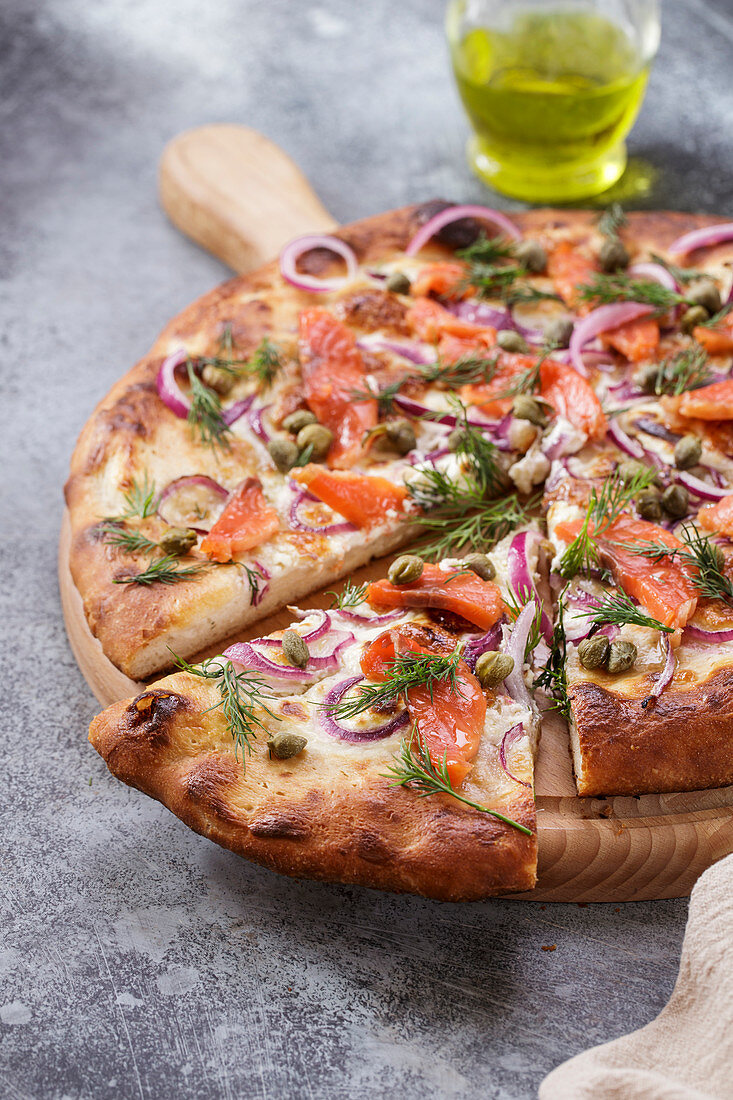 Pizza with smoked salmon close-up