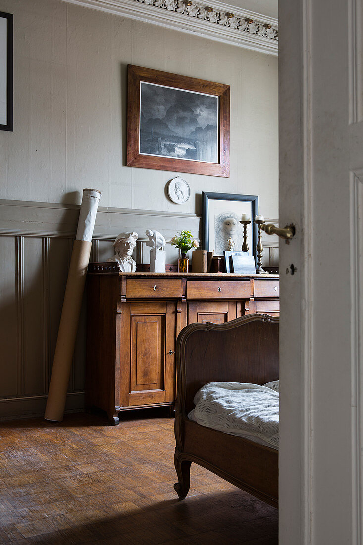 Antique furniture, wainscoting and stucco ceiling in bedroom