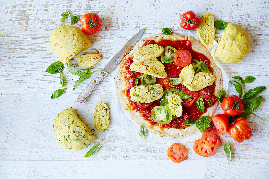 Flatbread with moxerella (vegan mozzarella), tomatoes and basil