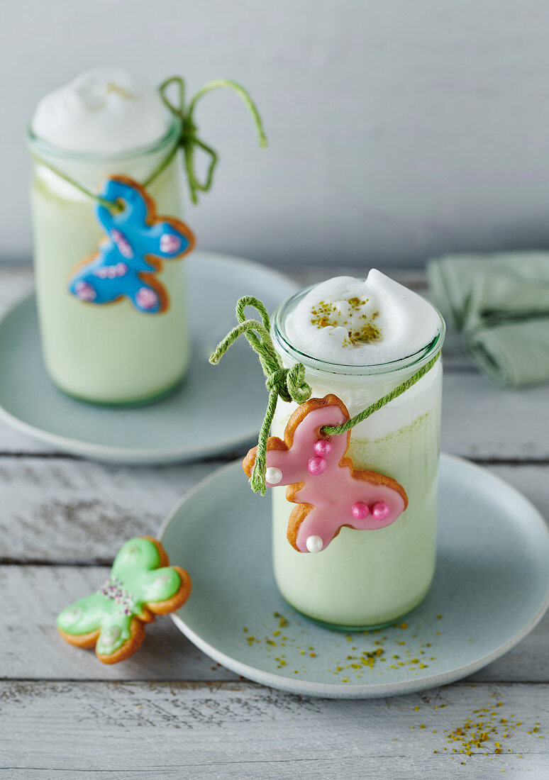Matcha milk with milk foam decorated for Easter with butterfly biscuits