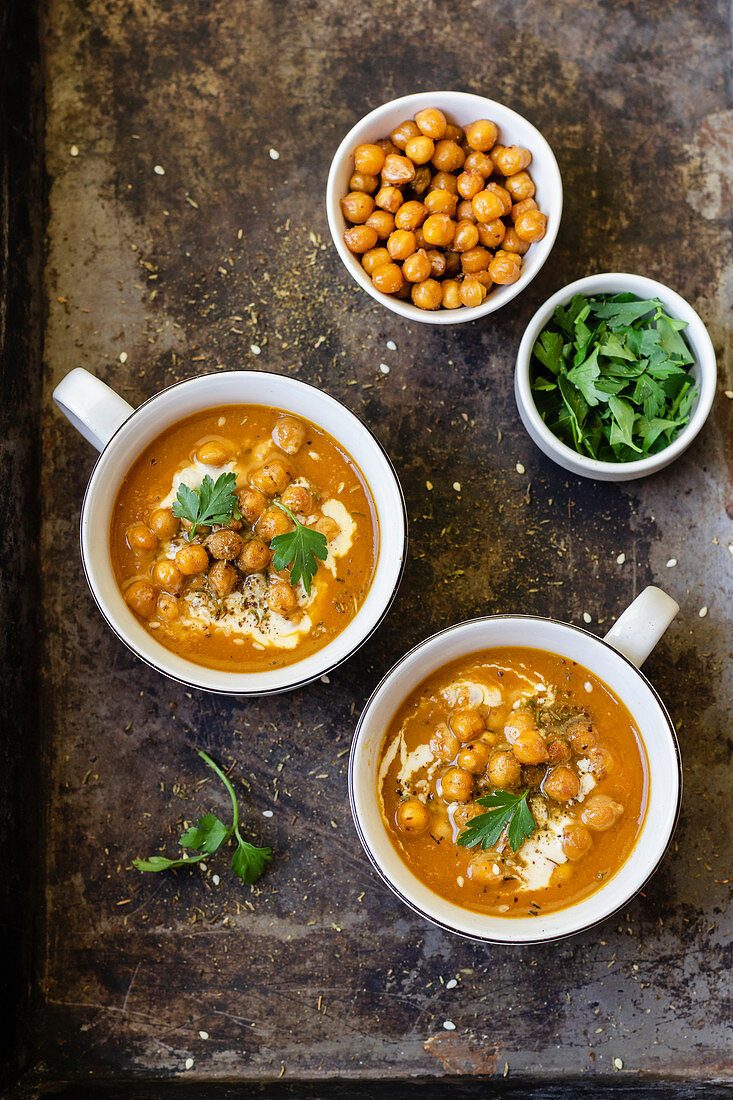 Carrot soup with baked chickpeas, tahini, zaatar and parsley