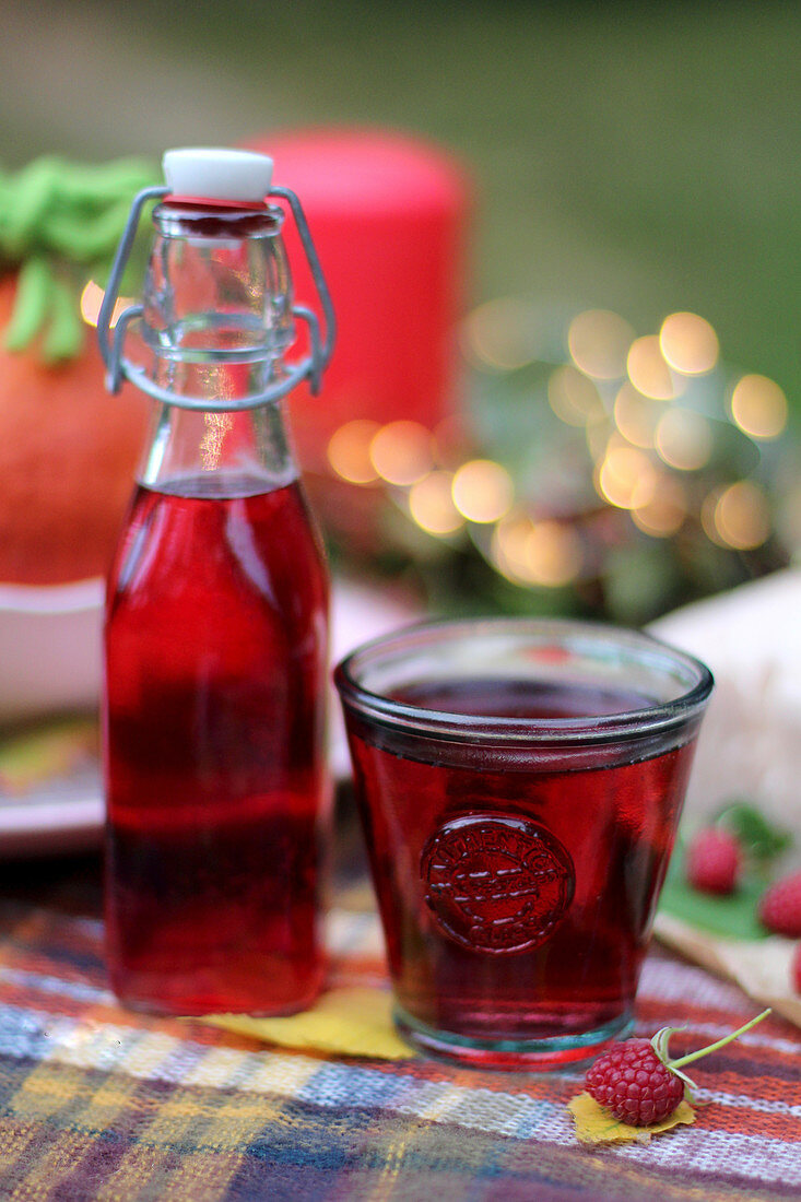 Raspberry juice on an autumnal table