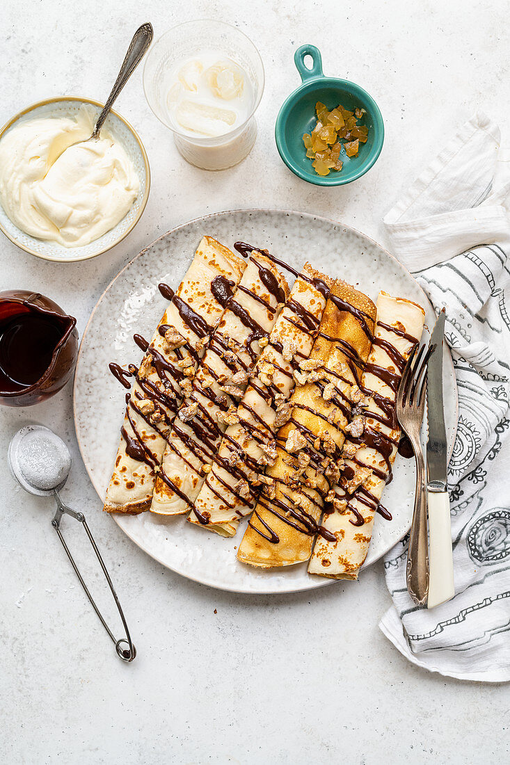 Pancakes with chocolate sauce and nuts