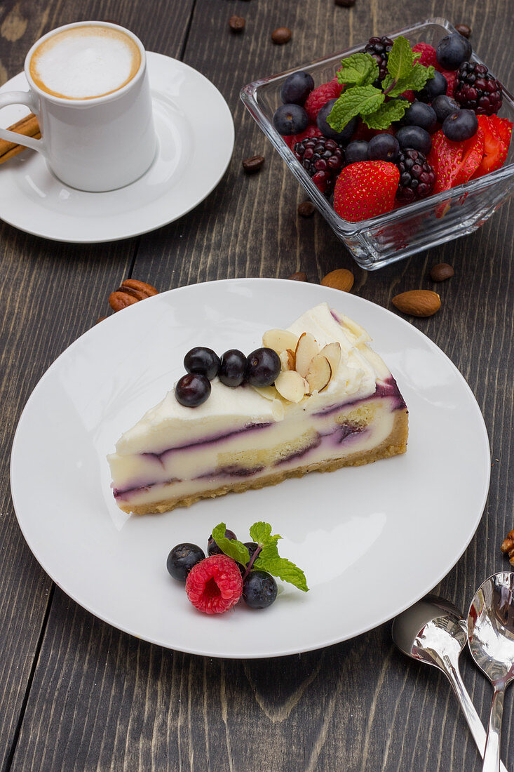 Iced coffee, white chocolate cake with blueberry and black cherries