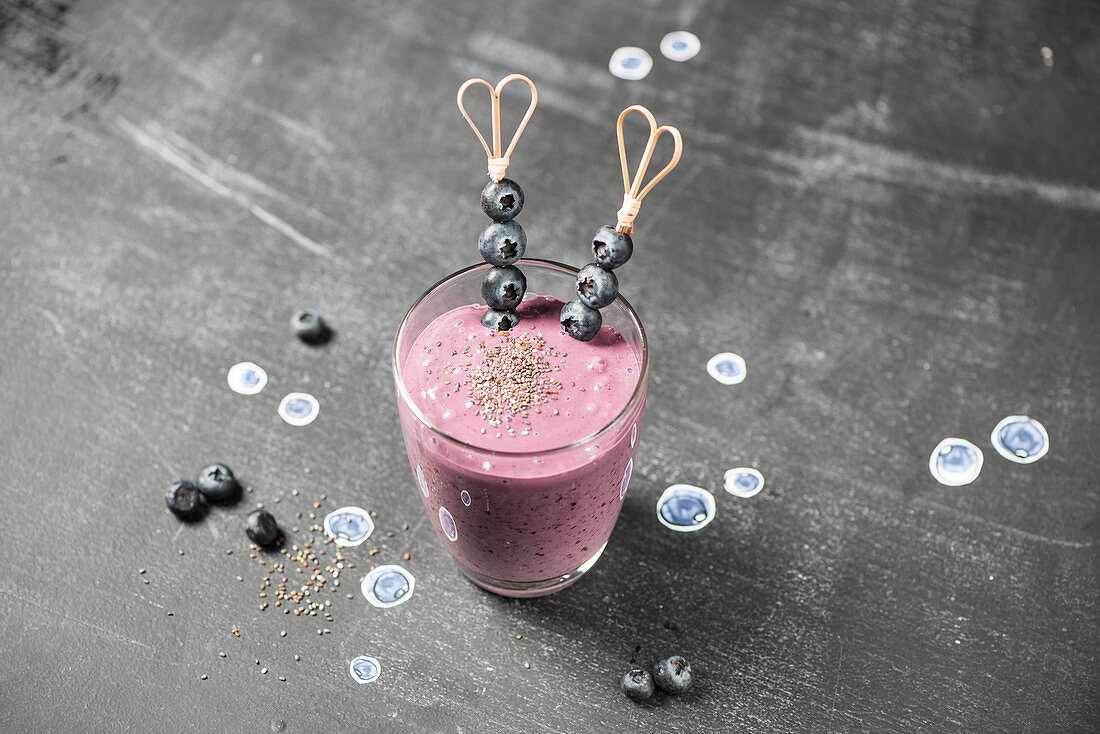 A blueberry smoothie with blueberry skewers