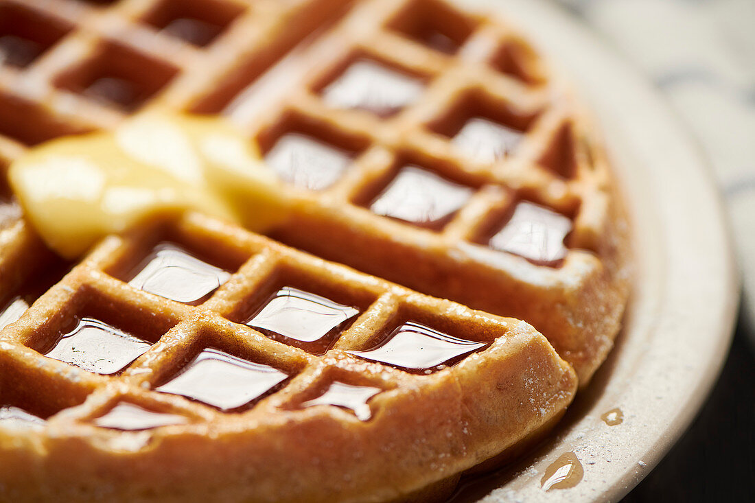 Whole belgian waffle with syrup and butter