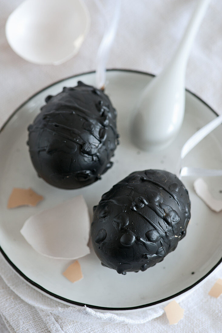 Blown eggs decorated with chalkboard paint and black wax