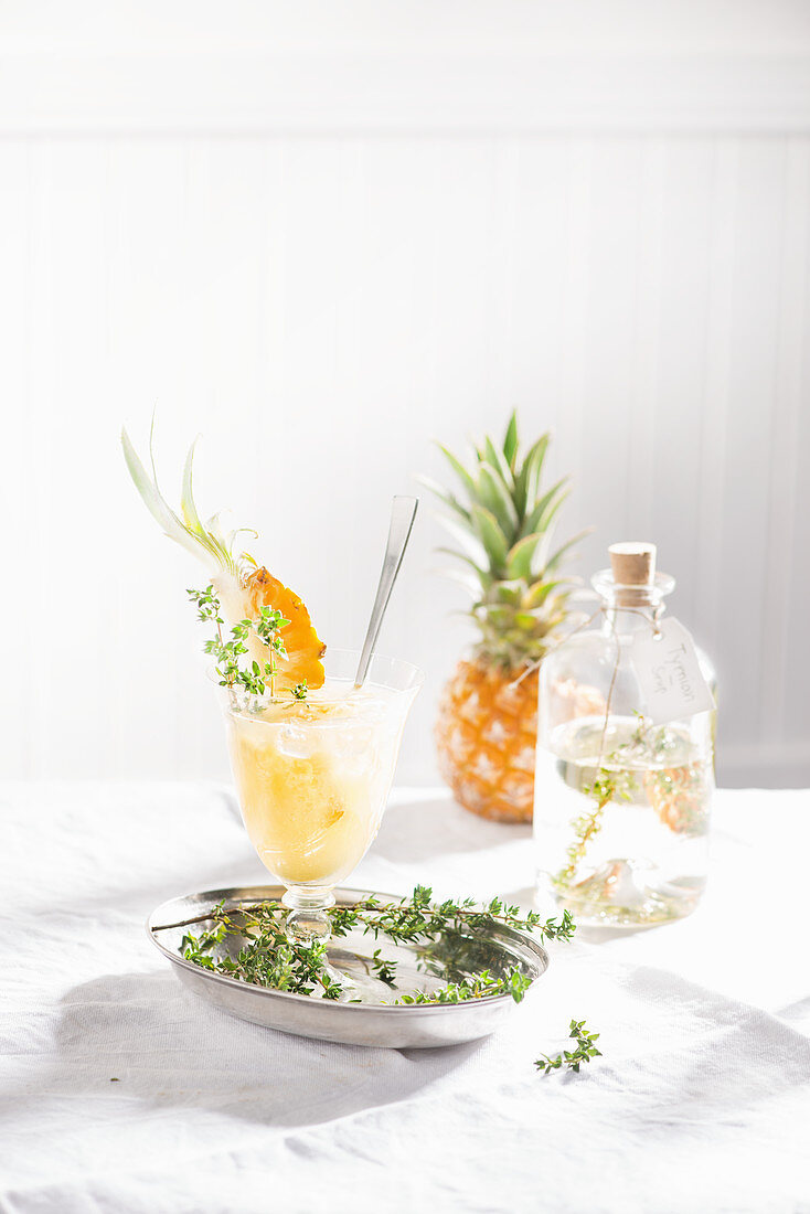 A sparkling summery pineapple drink with thyme syrup