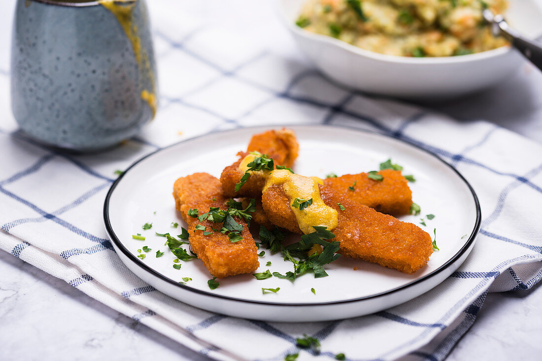 Vegan 'fish fingers' made from soya protein with a creamy herb sauce