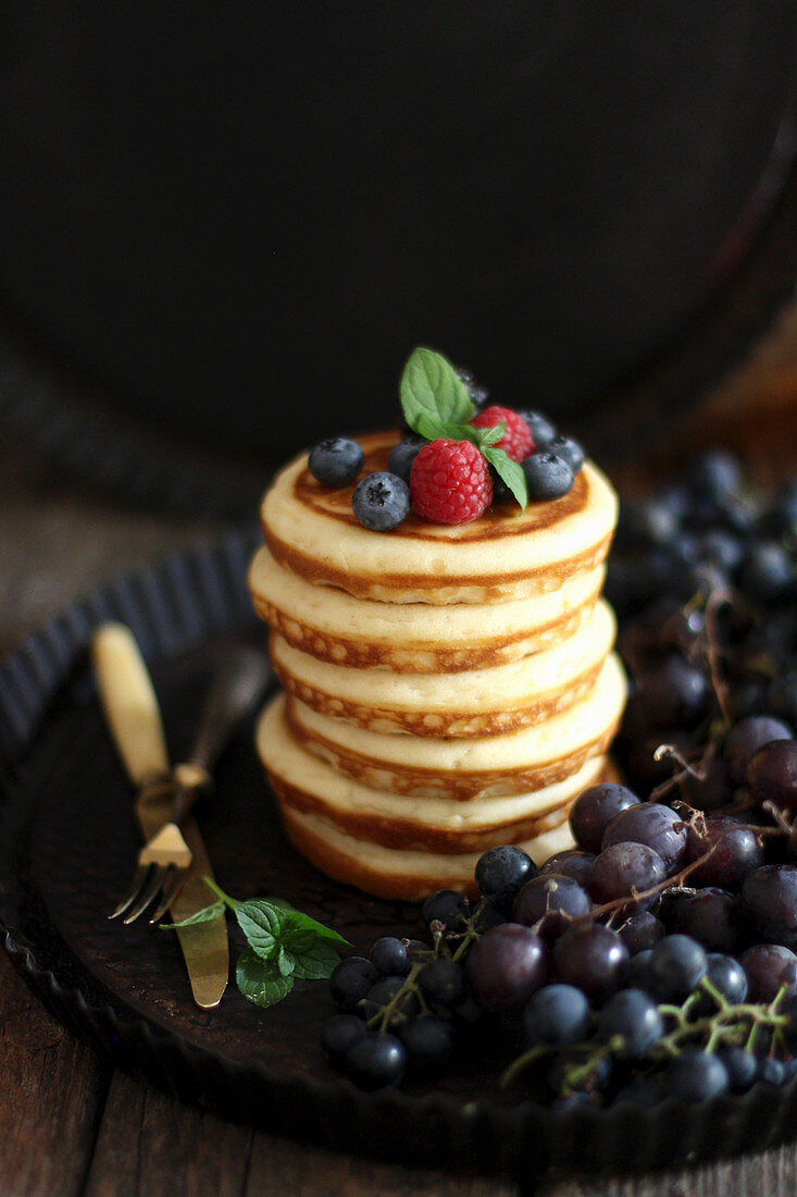 A stack of pancakes against a dark background