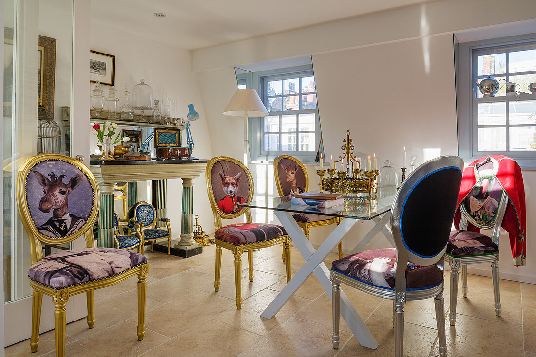 Baroque chairs with animal motifs on backrests around modern glass table in dining room