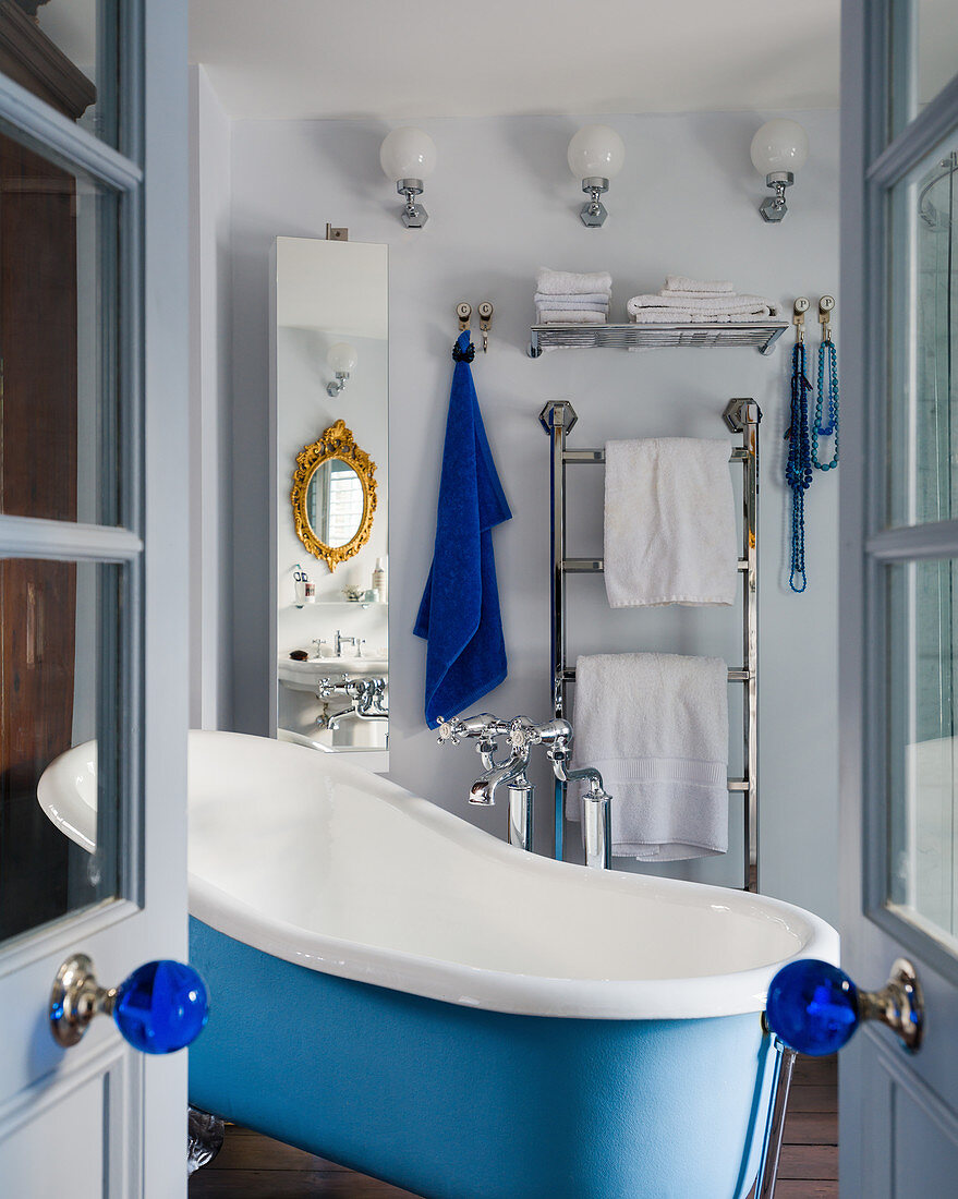 Free-standing bathtub in blue-and-white bathroom