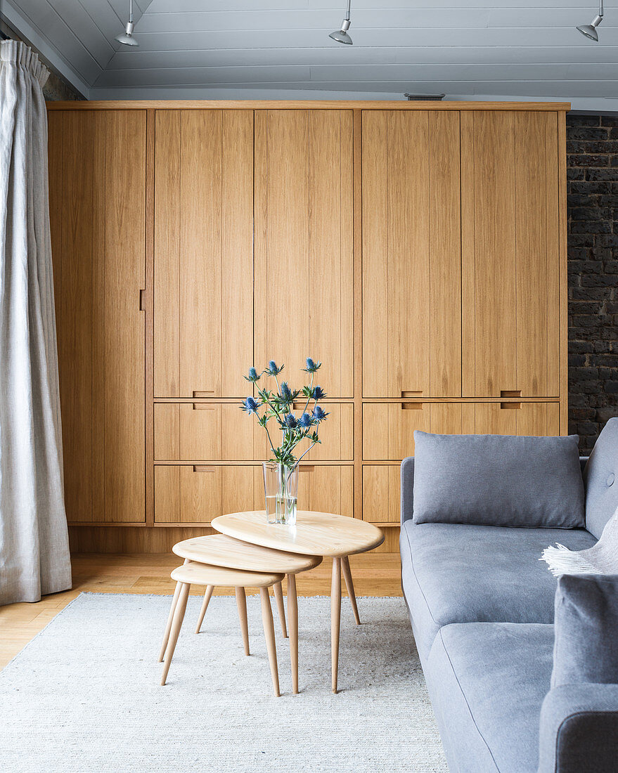 Modern wooden cupboards in grey living room