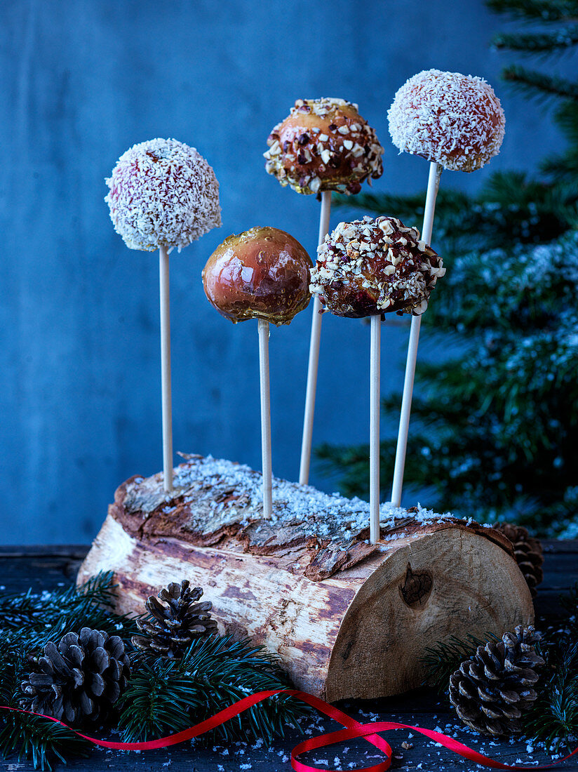 Candied apples with coconut flakes and nuts