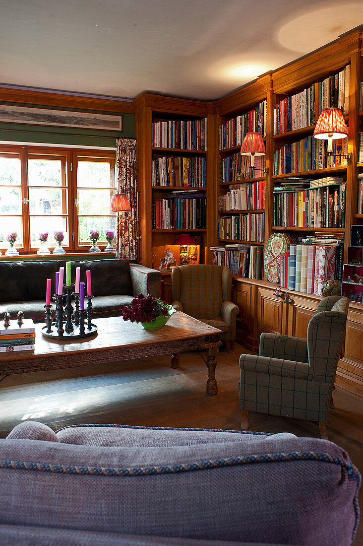 Fitted bookcases and various seating in living room