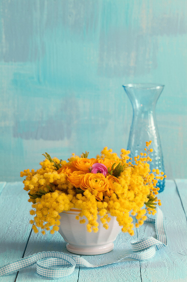 Small arrangement of mimosa and ranunculus