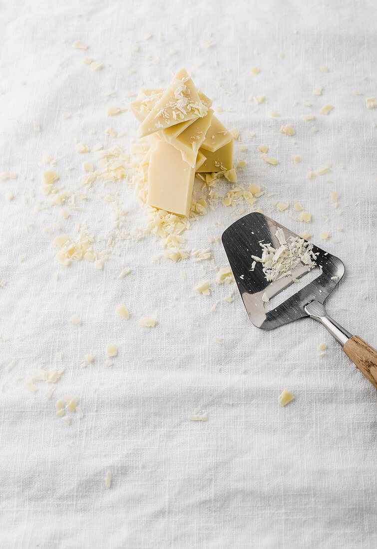 Chunks of white chocolate on white linen