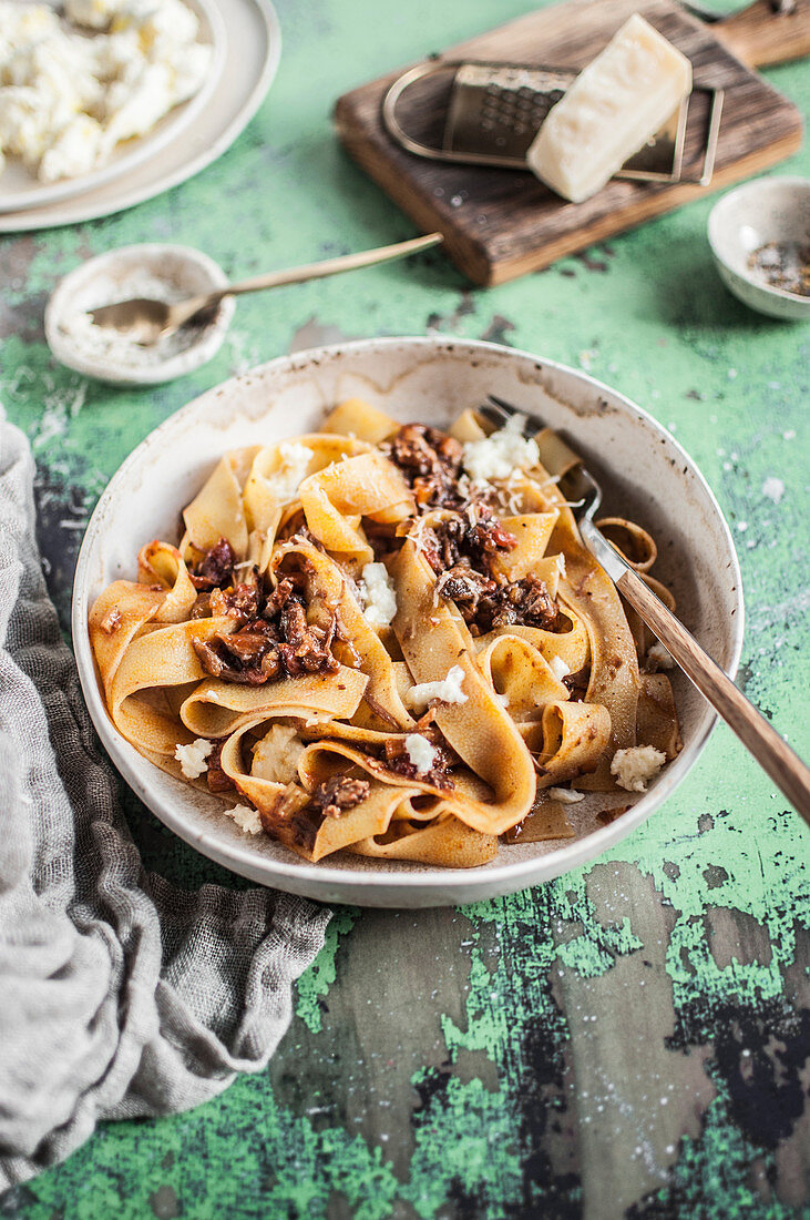 Pappardelle with beef ragu served with parmesan cheese and mozzarella cheese