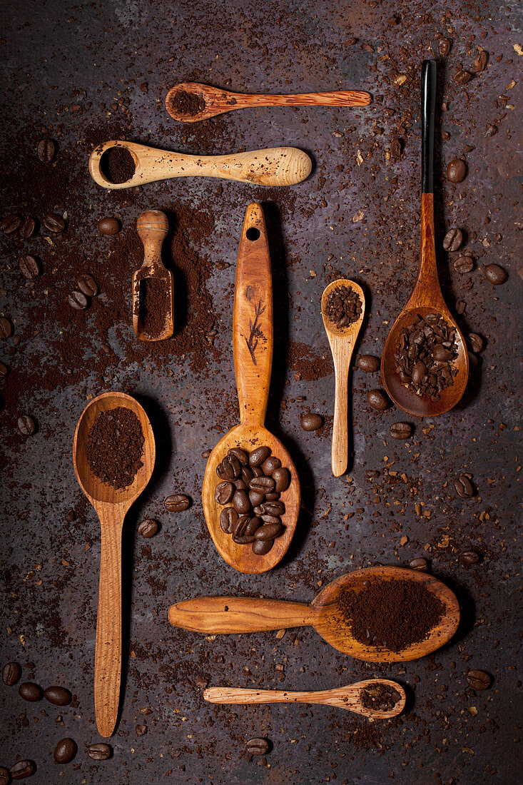 Coffee beans and Ground Coffee on various Wooden Spoons