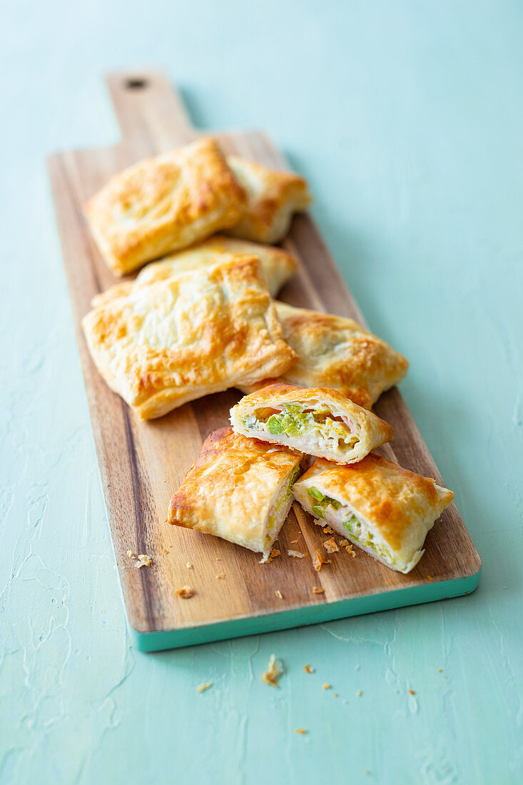 Stuffed puff pastry parcels filled with vegetables, ham and cheese