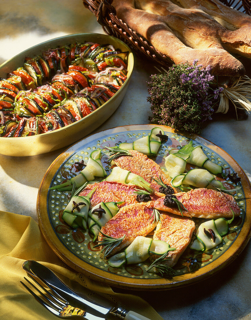 Rosemary red mullet fillets on a courgette salad served with a Provençal vegetable gratin