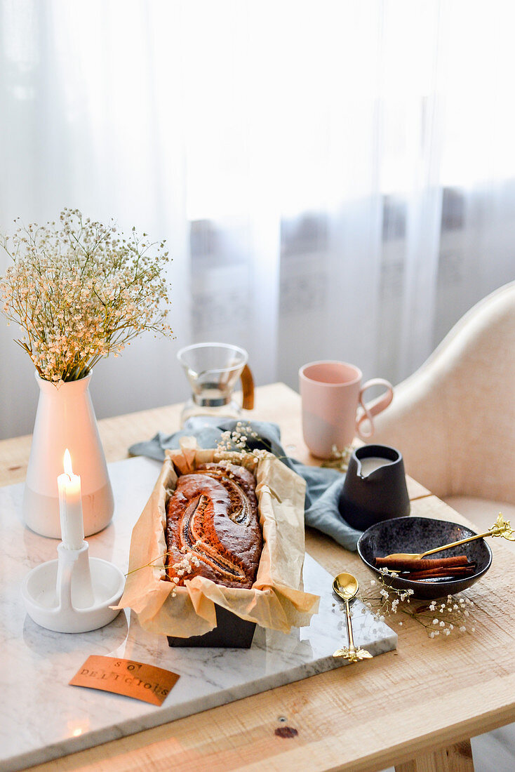 Banana bread in a mold on a wooden table