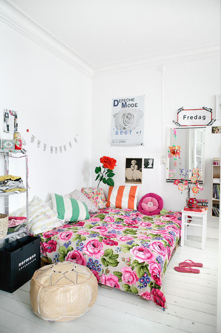 Floral bedspread on bed in teenager's bedroom