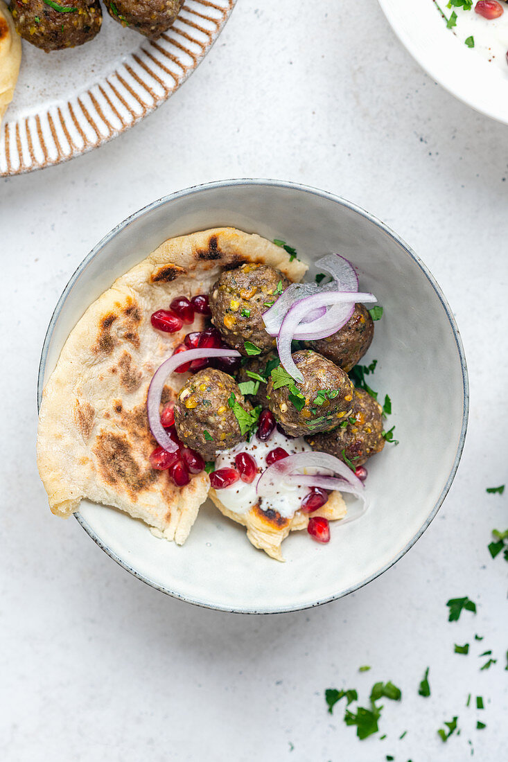 Lamb meatballs with naan and pomegranates